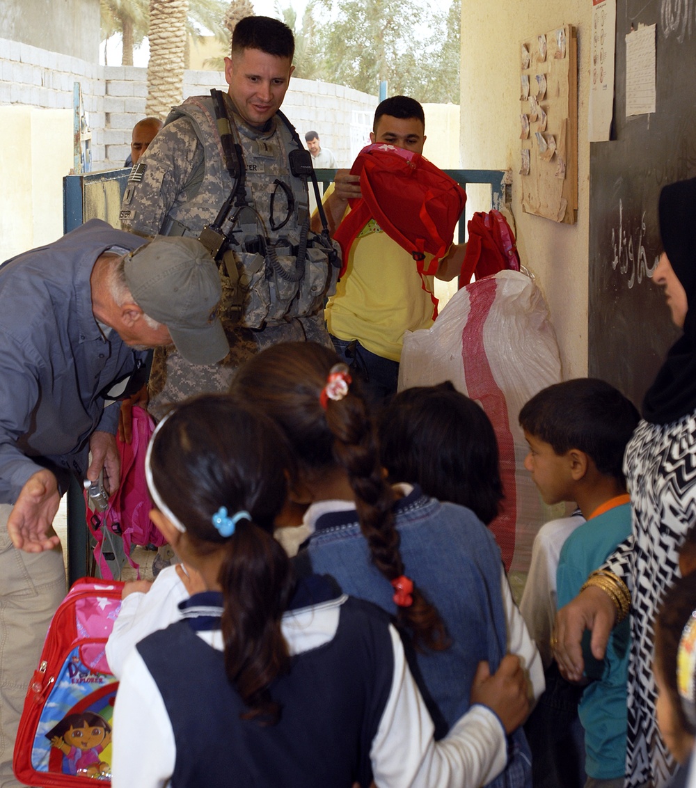 Soldiers, teachers give school supplies to local children
