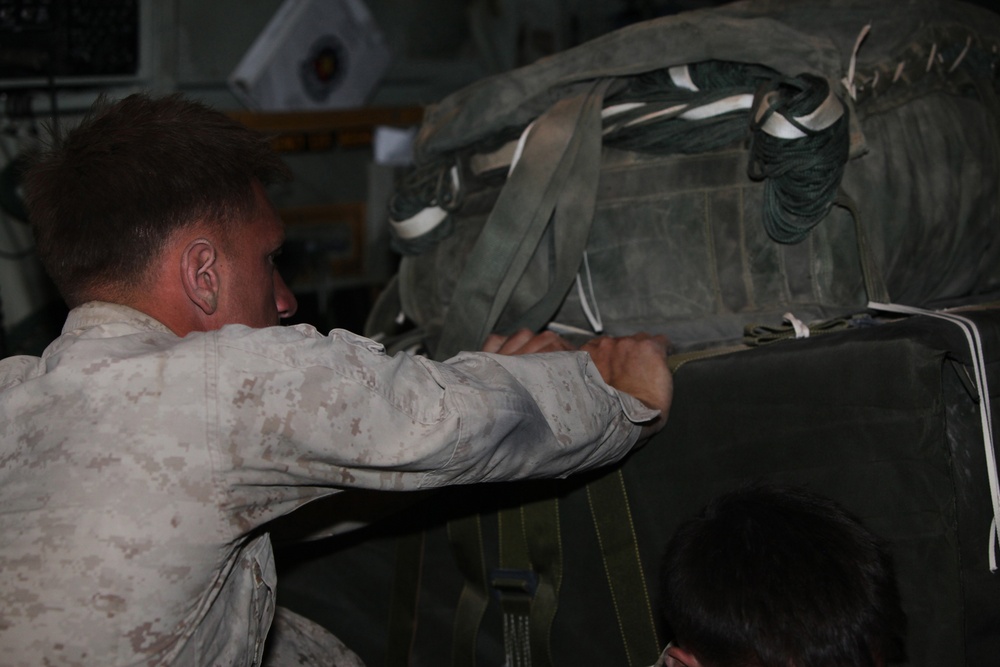 Marines load supplies onto C-130