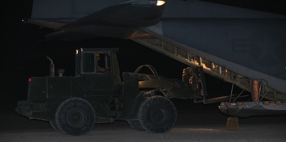 Marines load supplies onto C-130