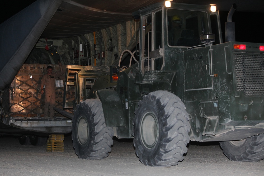 Marines load supplies onto C-130