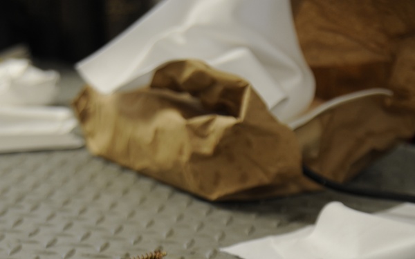 Service members clean weapons