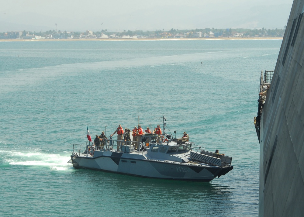 A Mexican navy patrol boat returns to USS Freedom