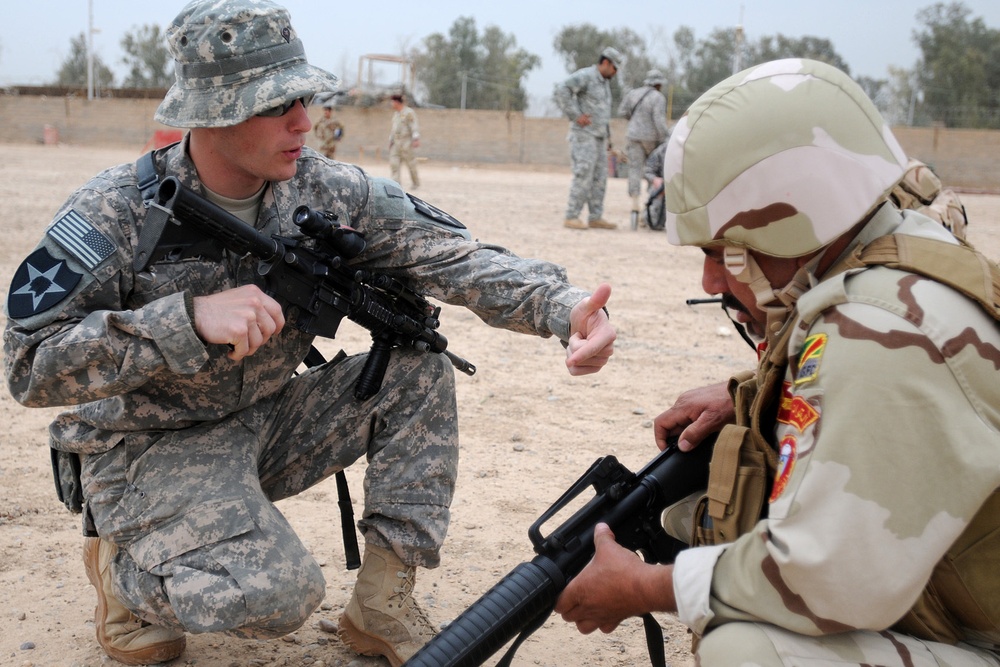 Iraqi soldiers lay down AK-47's, pick up M16's