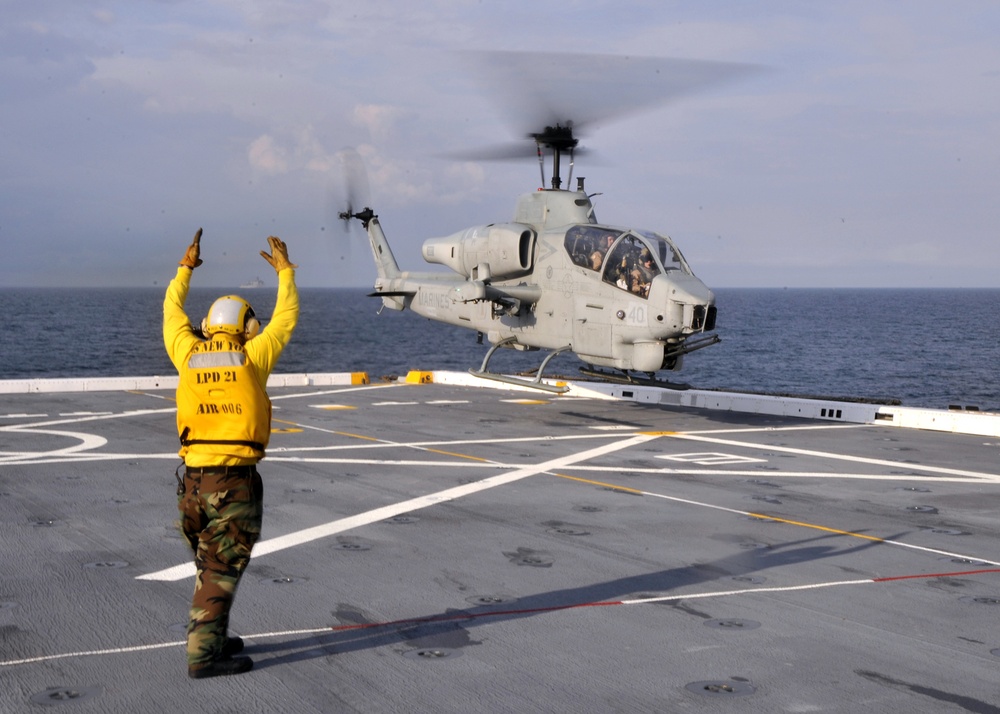 an AH-1 Cobra helicopter lands aboard USS New York