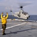 an AH-1 Cobra helicopter lands aboard USS New York
