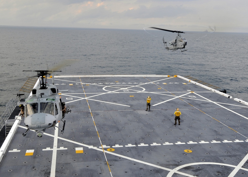 an AH-1 Cobra helicopter lands aboard USS New York