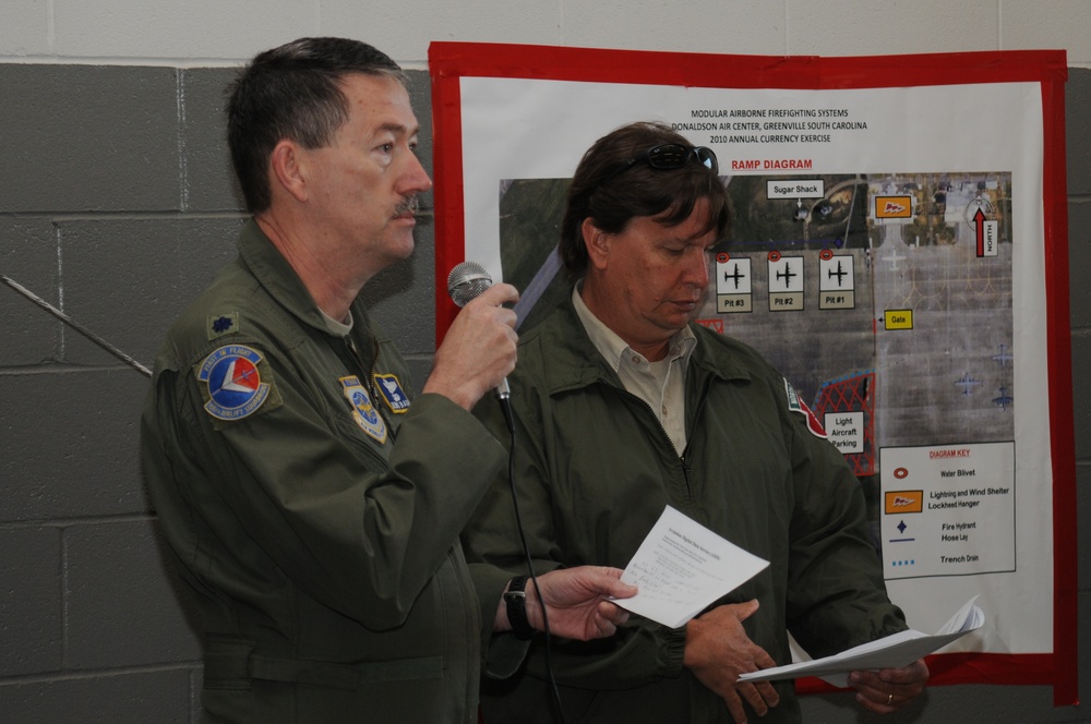 Lt. Col. Dennis Bailey and Lee Burwell of the North Carolina Forest Service Provide a Preflight Briefing to the Crew on the First Day of Flying for the MAFFS Training Exercise in Greenville, SC (Photo by Staff Sgt. Richard Kerner)