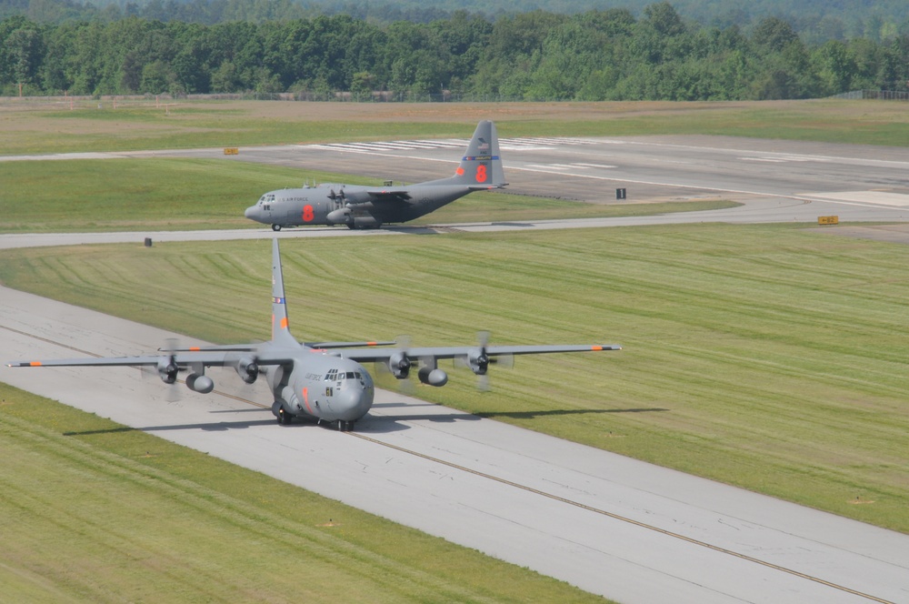 MAFFS Aircraft 7 and 8 of the 145 AW, North Carolina Air National Guard, Demonstrate the Hi-tempo of MAFFS Training As One Taxis Out to Lift-off and the Other Enters the Ramp to Reload Its Fire Retardant Cargo in Greenville, SC (Photo by Staff Sgt. Richar