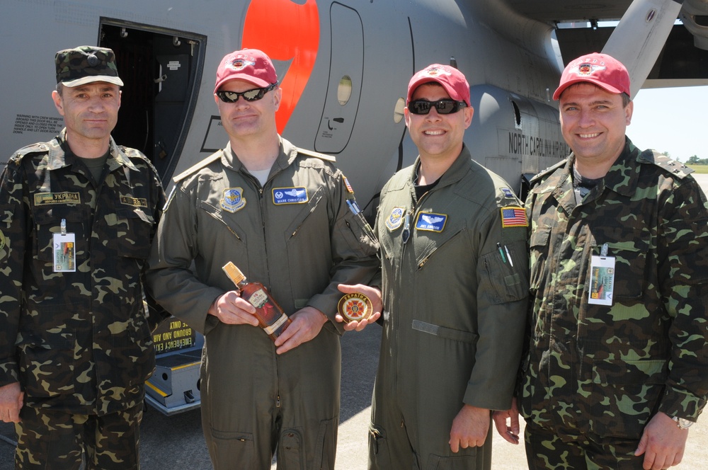 Col. Kozyrkov Ihor and Colleague From the Ministry of Defense of Ukraine Present NC Air National Guard Pilots Lt. Col. Mark Christen and Capt. Joel Kingdon with Officer Shoulder Boards and a Patch in Appreciation