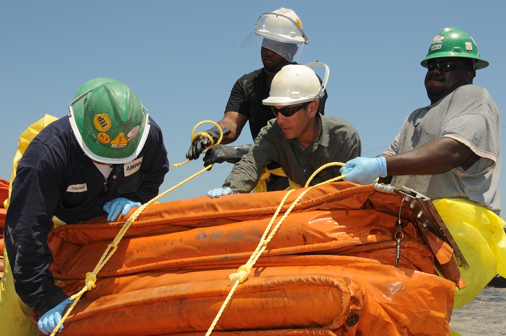 Decontamination Workers Bundle Oil Containment Boom