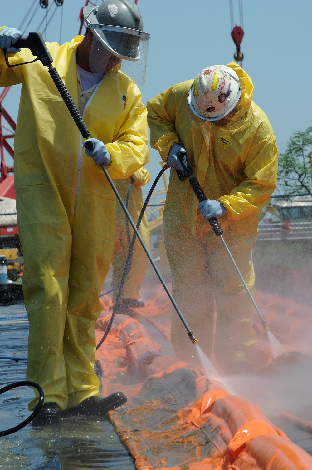 Decontamination Workers Bundle Oil Containment Boom