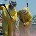 Decontamination Workers Bundle Oil Containment Boom