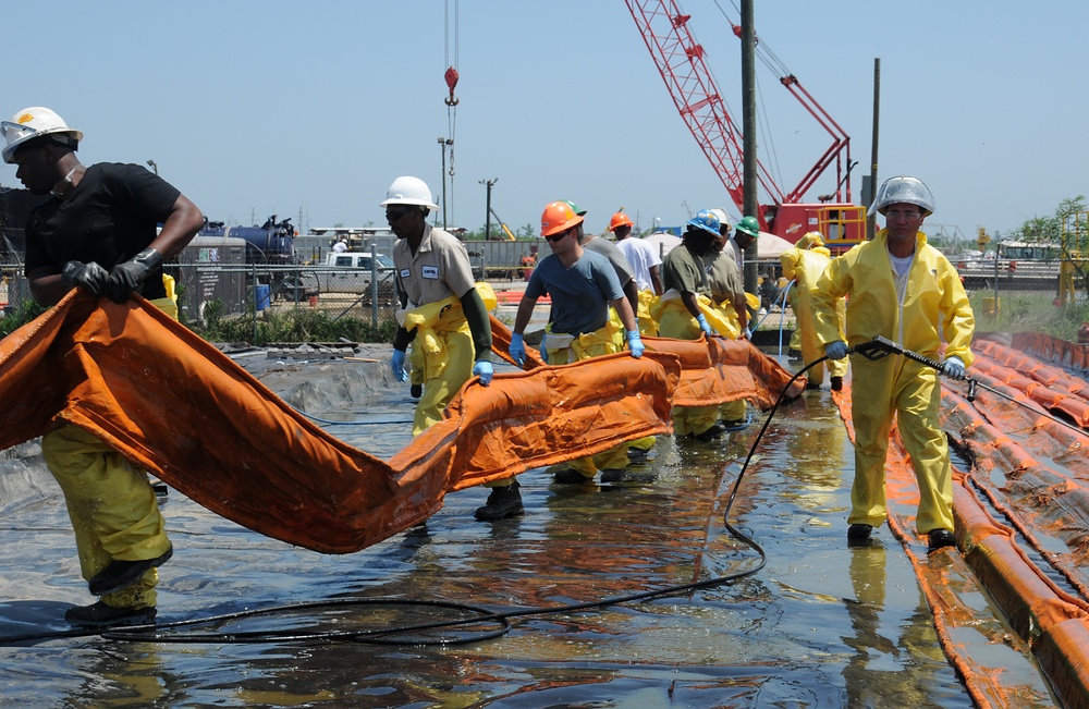 Workers at a Decontamination Site in Venice, La., Carry Oil Containment Boom