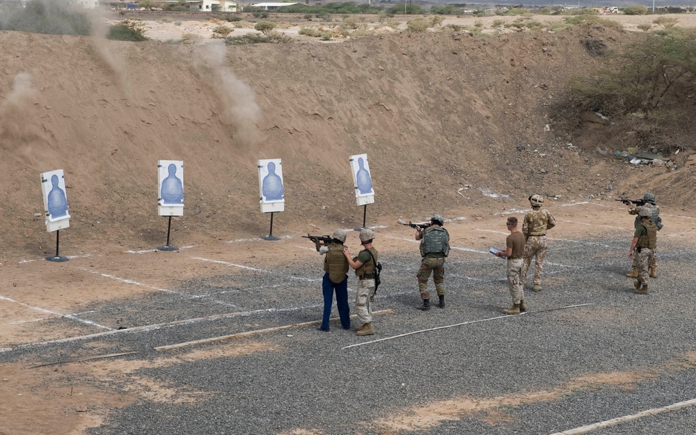 Service members fire weapons