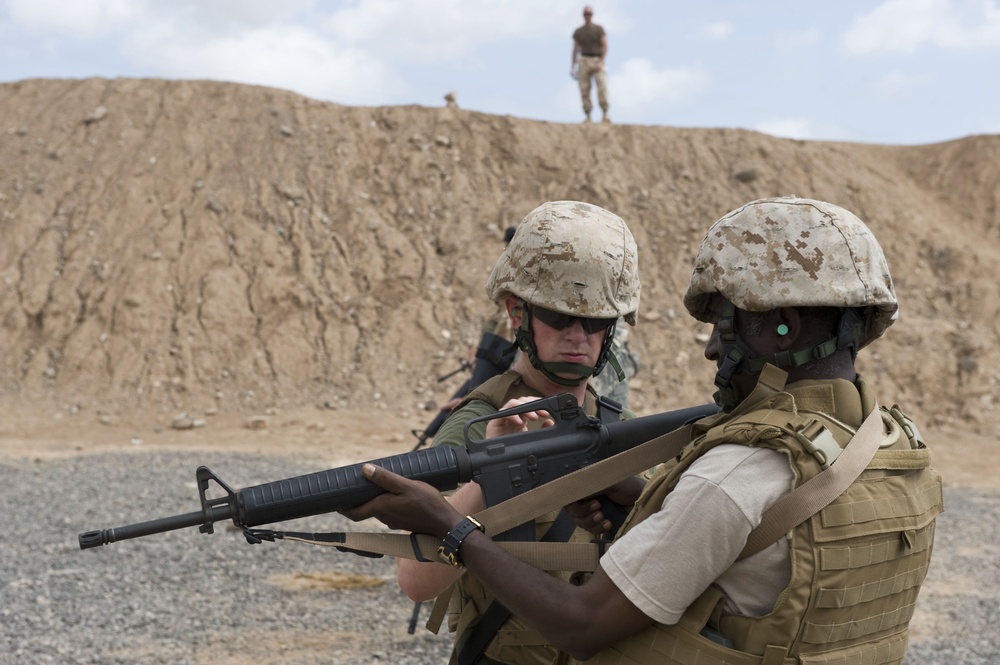 Service members fire weapons