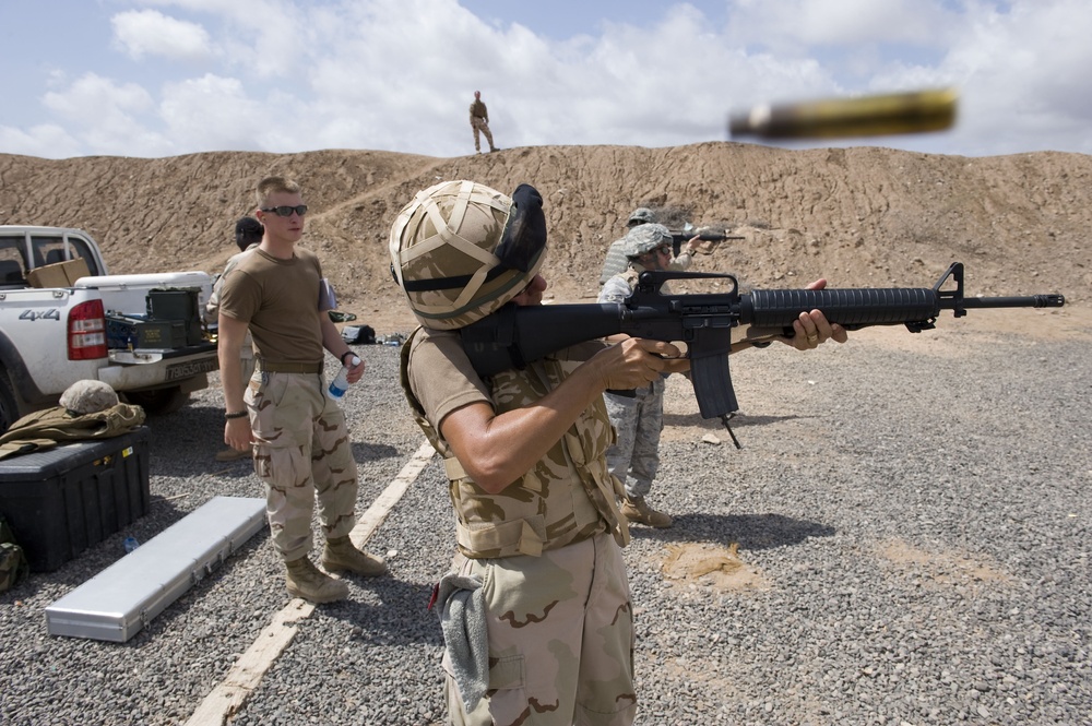 Service members fire weapons