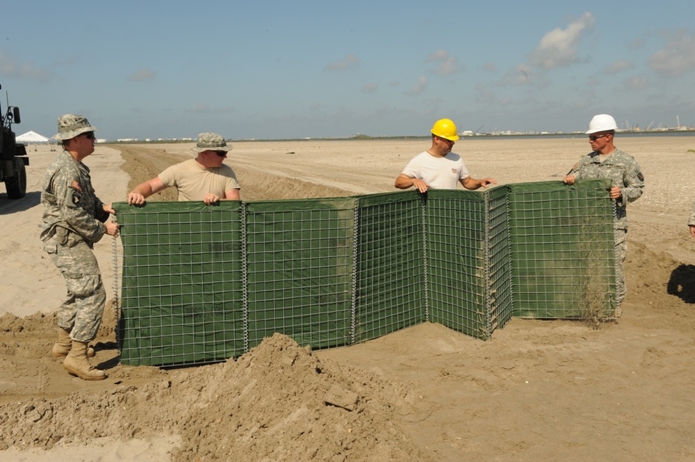 Guardsmen construct Hesco wall in Port Fourchon