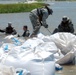Louisiana National Guardsmen fill breaches with sandbags for wetland protection