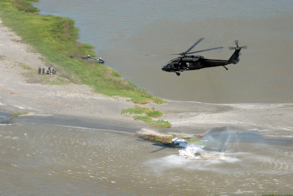 Louisiana National Guardsmen fill breaches with sandbags for wetland protection