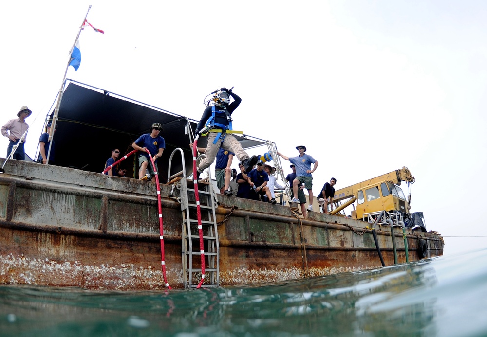 Sailors dive for remnants