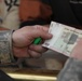Soldier monitors counterfeit money in market