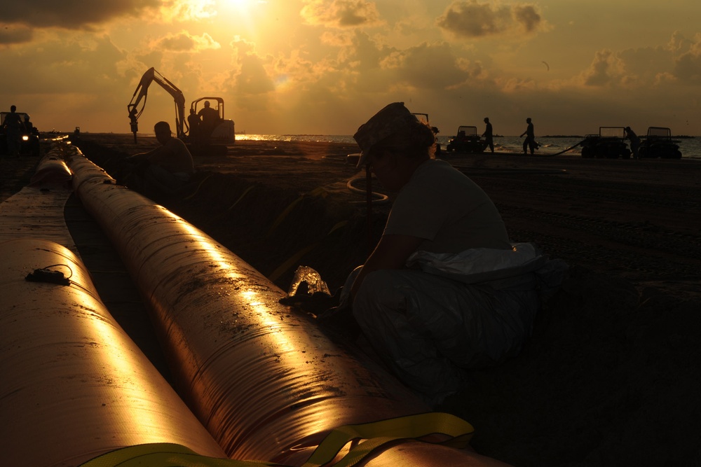 Louisiana National Guardsmen defend the shoreline around the clock