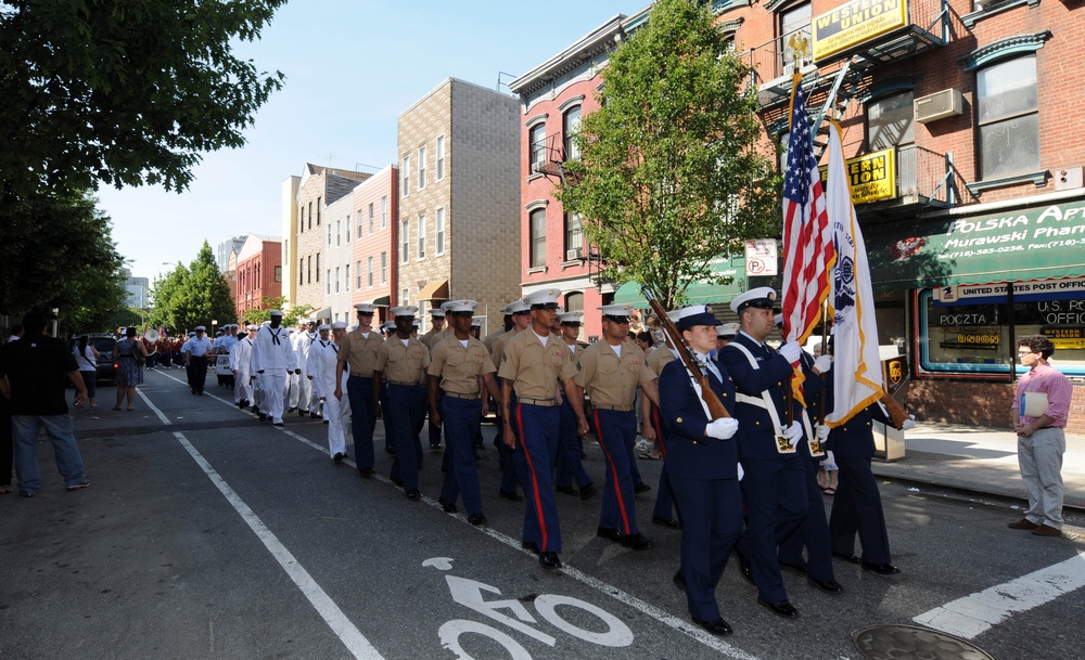 Coast Guard Sector New York, Staten Island color guard members lead Marines and Sailors through a downtown section of Greenpoint, Brooklyn, during the 10th annual Greenpoint Veterans Day parade. Approximately 3,000 Sailors, Marines and Coast Guardsmen are