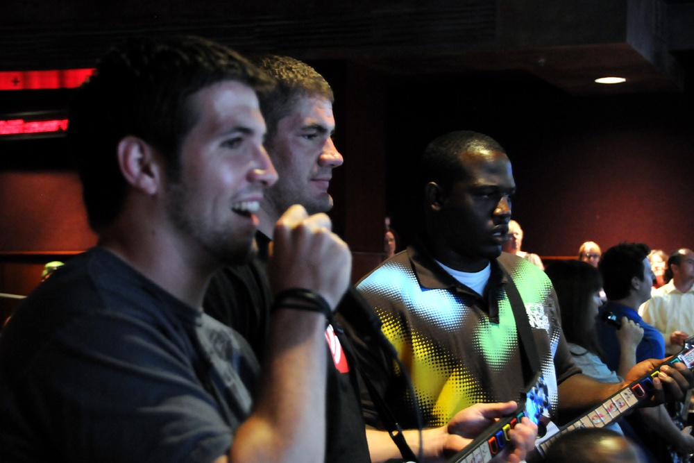 GIs Battle Football Pros at Video Games