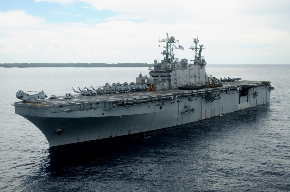 USS Peleliu passes its namesake island, renders honors