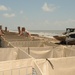 Louisiana National Guardsmen construct a Hesco Concertainer barrier wall along portions of the Cameron Parish coastline