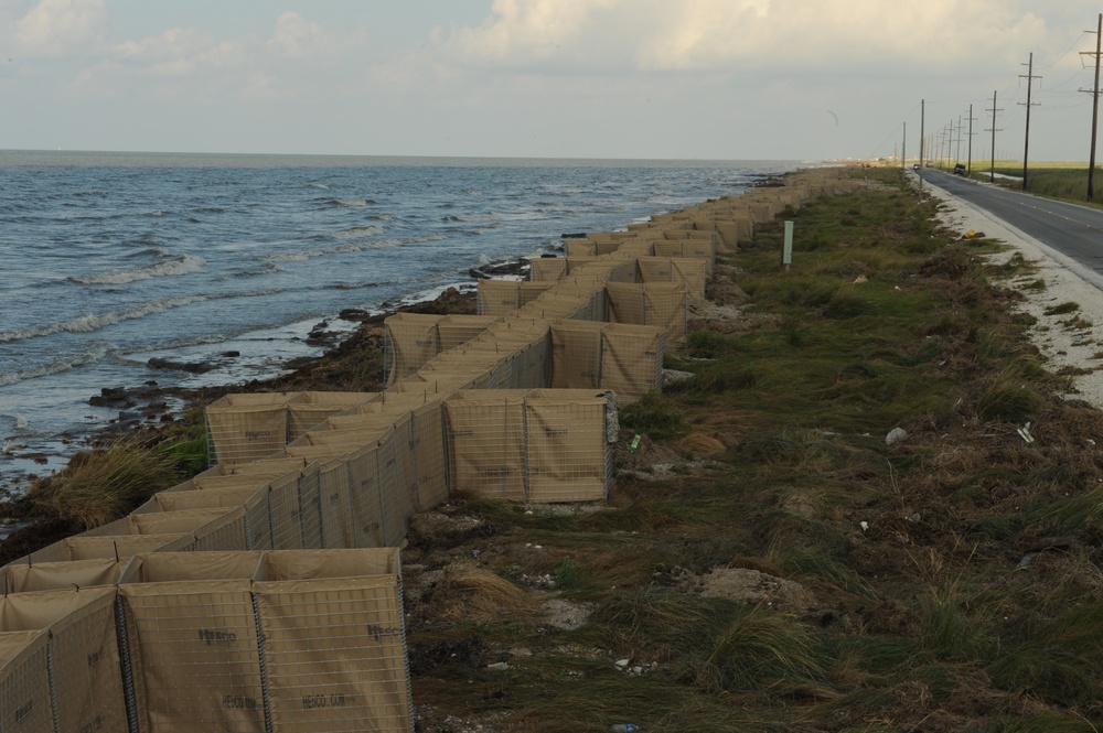 Louisiana National Guardsmen construct a Hesco Concertainer barrier wall along portions of the Cameron Parish coastline