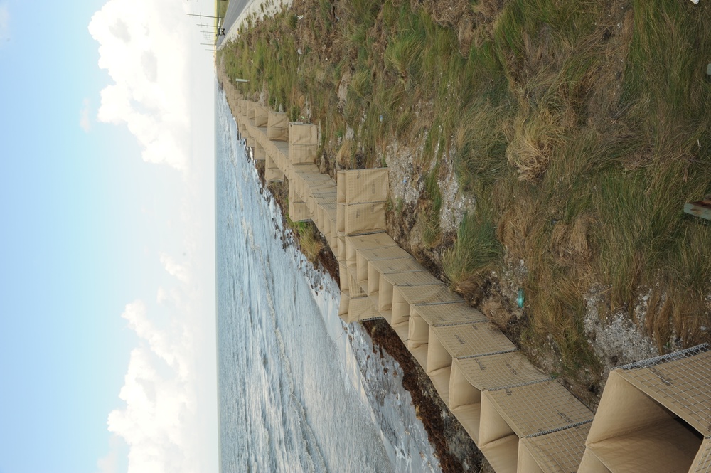 Louisiana National Guardsmen construct a Hesco Concertainer barrier wall along portions of the Cameron Parish coastline