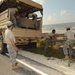 Louisiana National Guardsmen construct a Hesco Concertainer barrier wall along portions of the Cameron Parish coastline