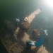Navy divers work to lift sunken engine block