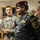 Two military/law enforcement personnel are shown in an indoor setting. A U.S. Army soldier identified by name tape as 'YANEY' stands alongside an Iraqi Federal Police commander wearing a dark blue digital camouflage uniform with a maroon beret. The Iraqi officer displays three-star rank insignia and a 'Federal Police Command' shoulder patch along with an Iraqi flag patch.