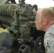 Field Artillery Soldier Aligns Howitzer