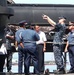 Sub commander talks to security during port visit