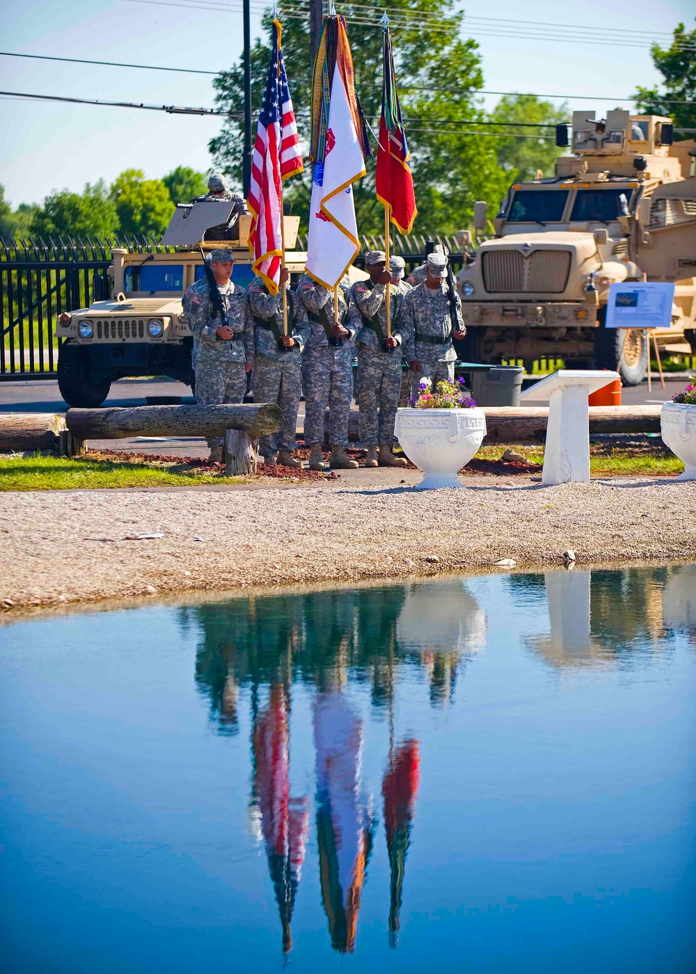 The 205th Infantry Brigade, First Army Division East Color Guard stands posted during the brigade's change-of-command ceremony held at the Veteran's Memorial, Camp Atterbury Joint Maneuver Training Center in central Indiana June 30.