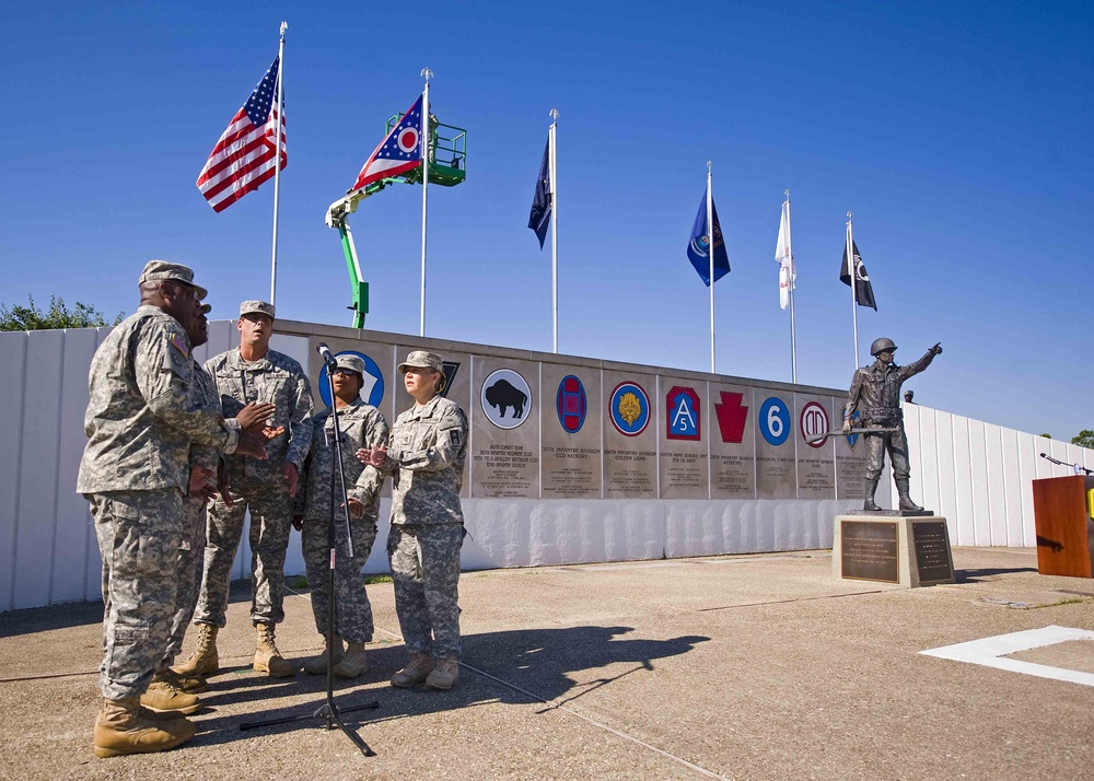 Soldiers of the 205th Infantry Brigade, First Army Division East sing &quot;American Soldier&quot; at the Veteran's Memorial, Camp Atterbury Joint Maneuver Training Center in central Indiana June 30 at the brigade's change-of-command ceremony.