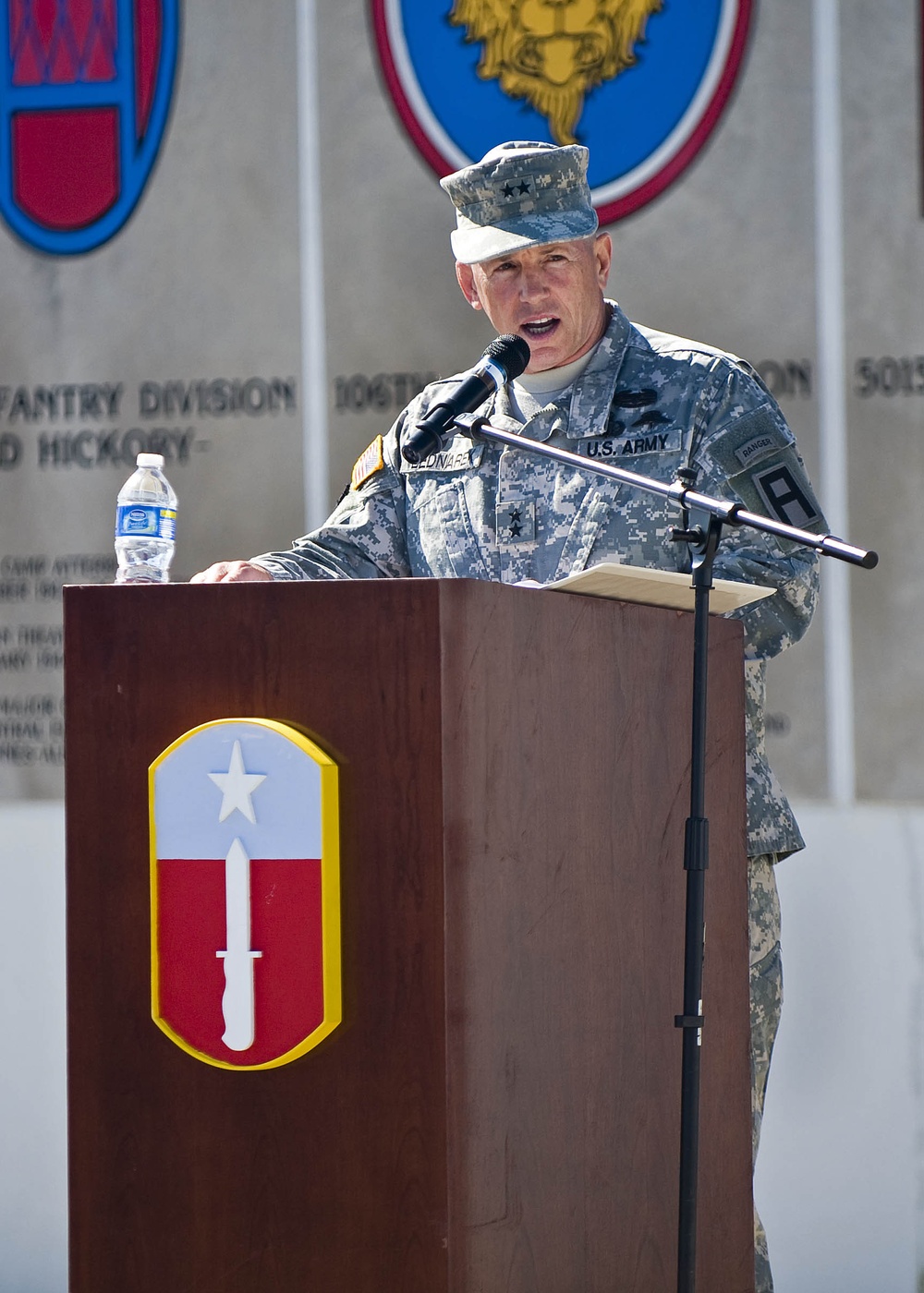 First Army Division East Commanding General Maj. Gen. J. Michael Bednarek welcomes the 205th Infantry Brigade's incoming commander at the brigade's change-of-command ceremony held at the Veteran's Memorial, Camp Atterbury Joint Maneuver Training Center in