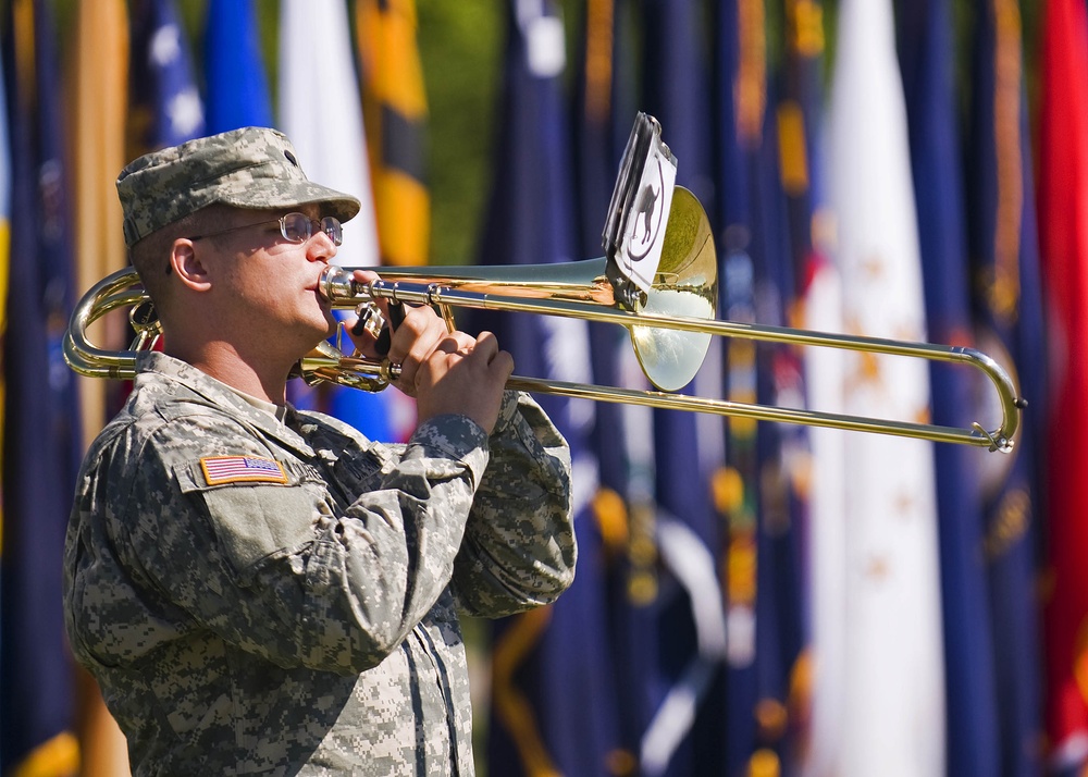 Spc. Chris Currens of London, Ky., a band member in the 100th Army Band, plays the trombone during the 205th Infantry Brigade, First Army Division East change-of-command ceremony held at the Veteran's Memorial, Camp Atterbury Joint Maneuver Training Cente