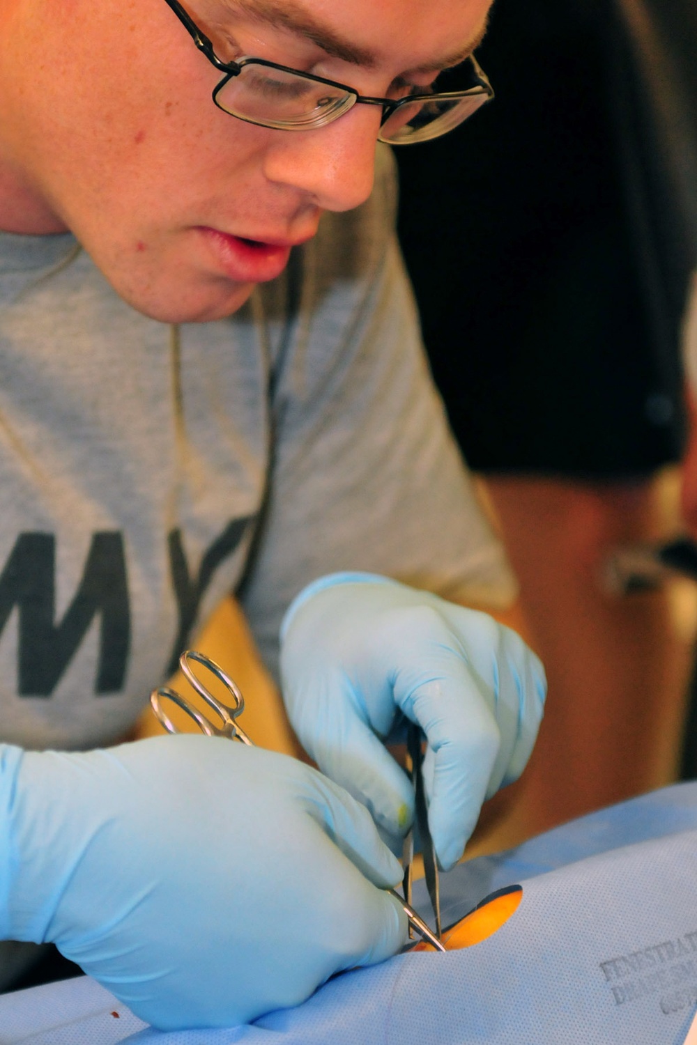 1st Armored Division medics practice suturing on pig's feet