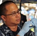 Petty Officer 1st Class Thomas Cabuco, hospital corpsman, assigned to Naval Medical Center San Diego, draws Tuberculin Purified Protein Derivative into a syringe to be used in free Tuberculosis testing for homeless veterans during the Veteran's Village of