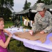Master Sgt. Karen Erickson, of the 119th Wing, right, creates a t-shirt voicing her feelings against sexual assault, July 29, on the Veteran's Administration Hospital grounds in Fargo, N.D.  Erickson is being assisted by Staff Sgt. Heather Prigge, also of