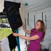 Staff Sgt. Heather Prigge, of the 119th Wing, talks about a t-shirt on a clothesline project display, July 29, on the Fargo, N.D. Veteran's Administration Hospital grounds. The Clothesline Project display is using t-shirts created by victims of military s