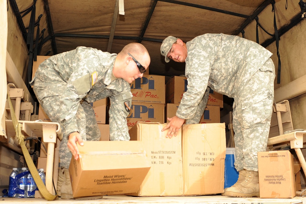 Guardsmen help first lady of Louisiana deliver school supplies