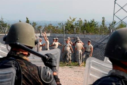 Multinational riot control training, U.S. soldiers play rioters