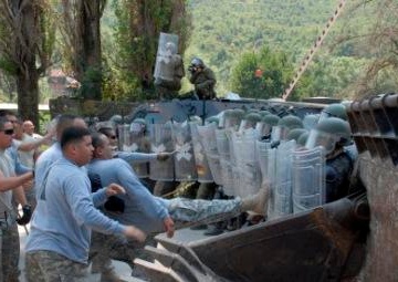 Multinational riot control training, U.S. soldiers play rioters