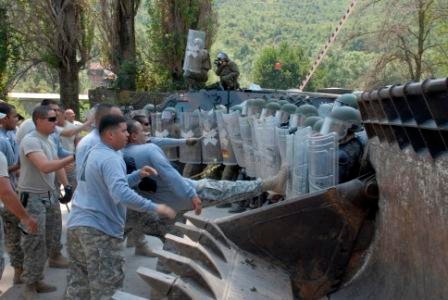 Multinational riot control training, U.S. soldiers play rioters