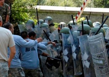 Multinational riot control training, U.S. soldiers play rioters